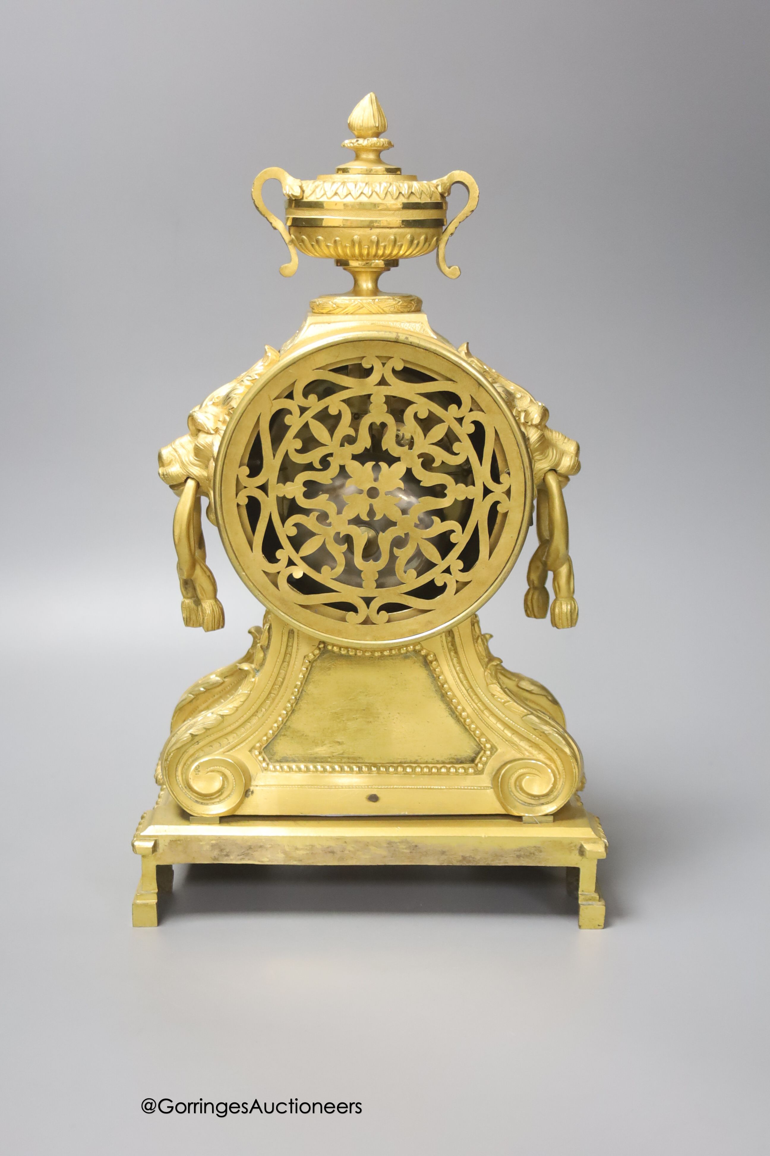 A 19th century French ormolu clock, with lion mask ring handles, 34cm